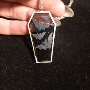 Stained glass coffin pendant with bats